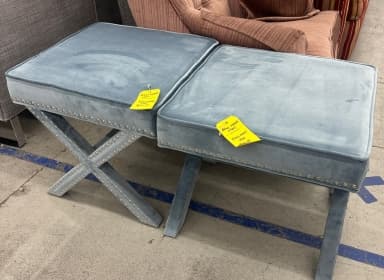 two blue stools with studs around the trim sitting inside the ReStore