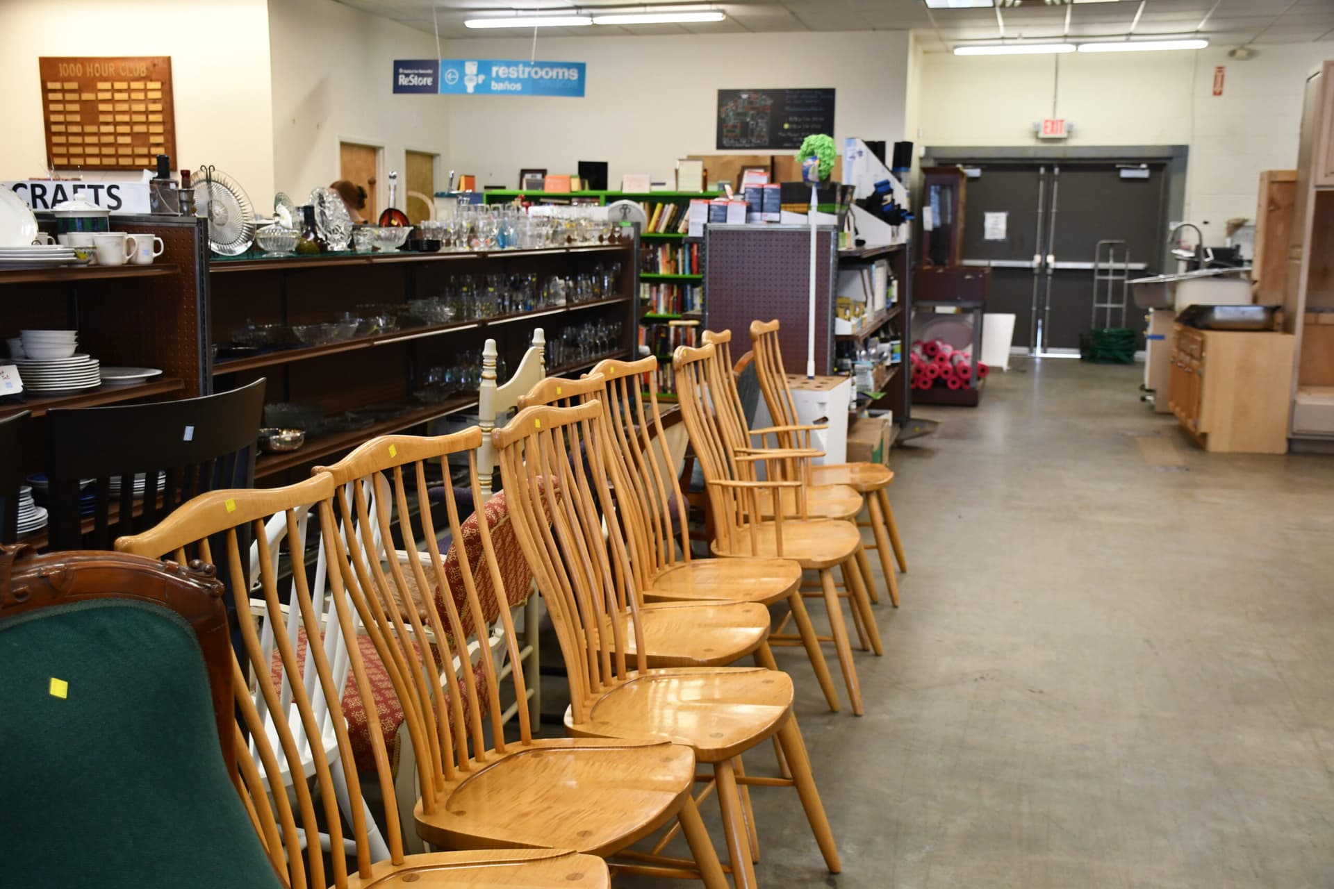Row of wooden chairs in store aisle
